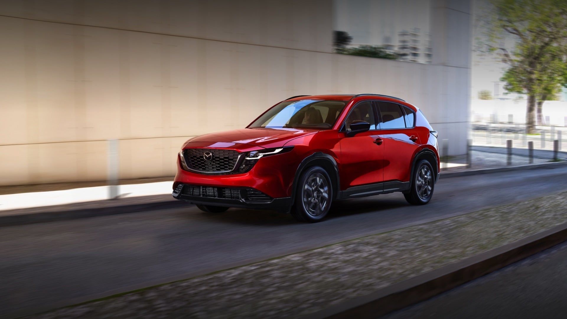 Red Mazda CX-5 driving near building